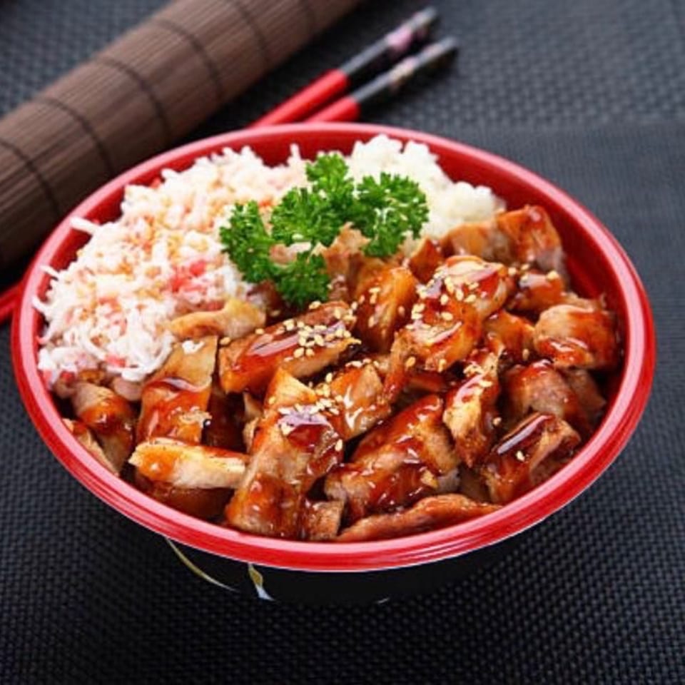 Red Lotus Noodle House teriyaki chicken and rice bowl with crab salad and parsley garnish.